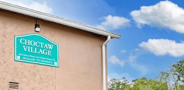 A sign on a building that says Choctaw Village.